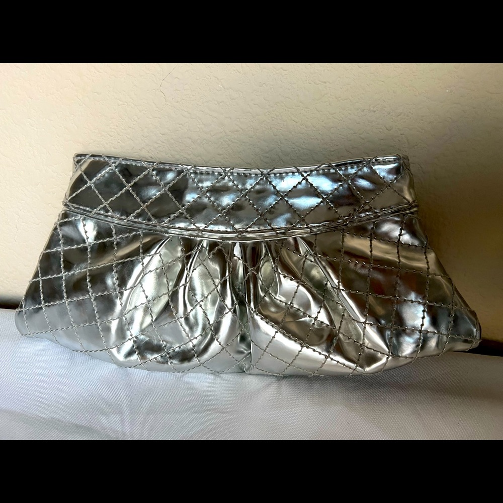 Silver clutch purse which has silver chain. No tag 100%PVC